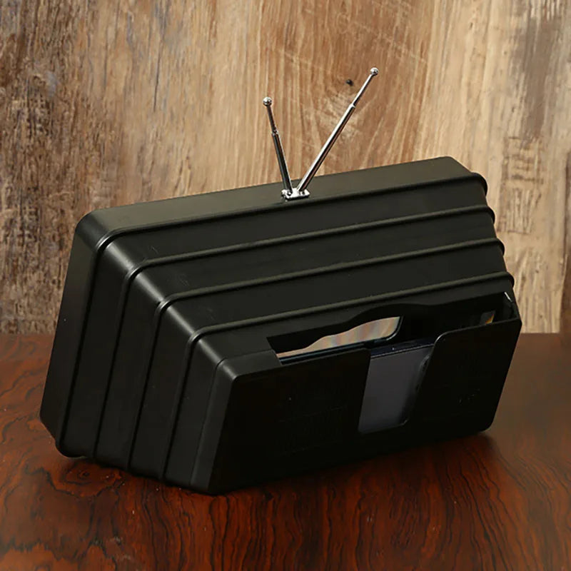 Screen magnifier for phones, black plastic ribbed stand with phone slot.