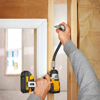 Flexible right-angle drill attachment with hex shank connection. Person using a drill to install a wooden frame, with a focus on home improvement.